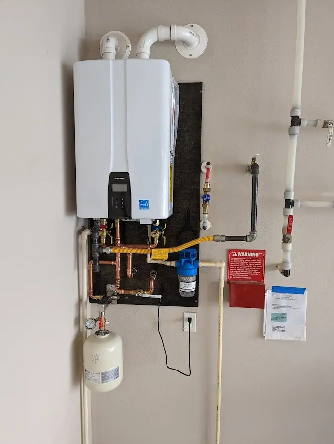 Professional plumber installing copper piping in a Fort Shawnee home